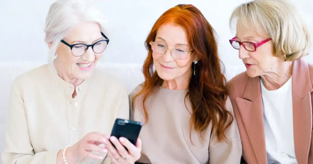 women using smartphone to use apps like the sony hearing control app to use with hearing aids